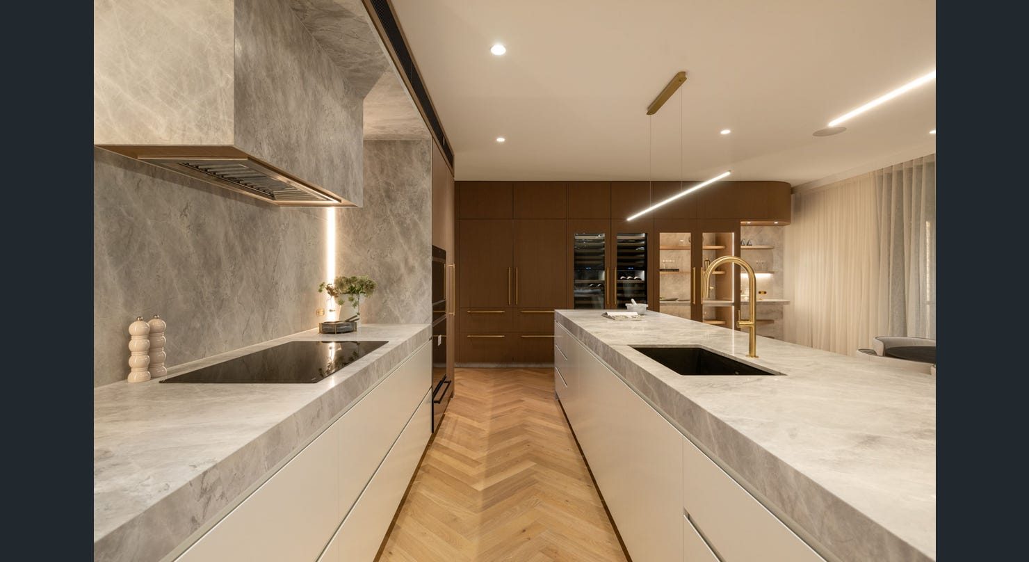 Kitchen with natural stone benchtops and timber veneer cabinetry